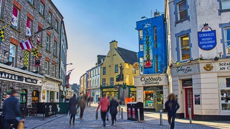 Visitors along the streets of Galway with colourful shopfronts