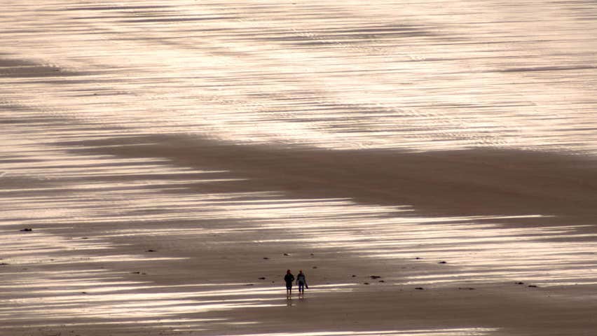Couple walking on Inch Beach in County Kerry