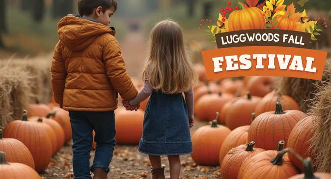 2 small children walking down a path lined with large pumpkins and bales of hay.