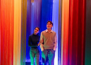 Couple walking through a rainbow coloured room