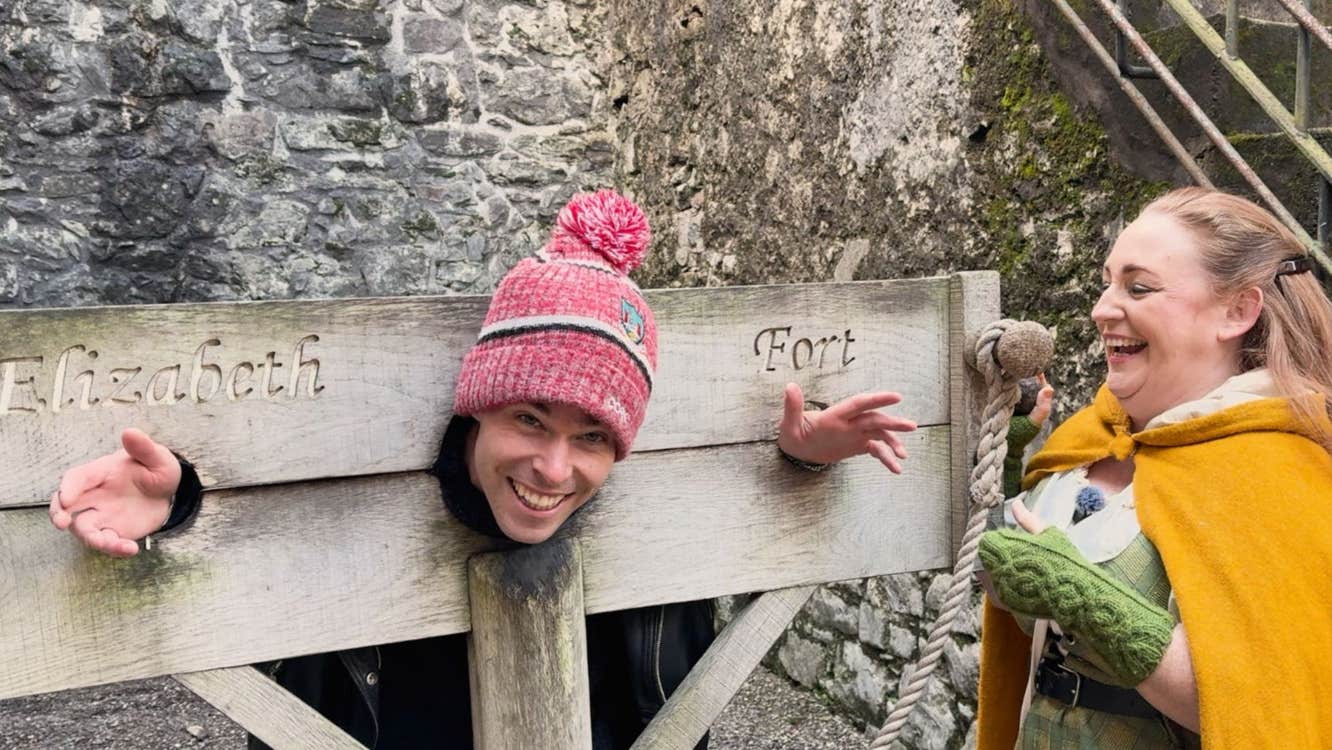 The tour guide and guest at the guillotine in Elizabeth Fort