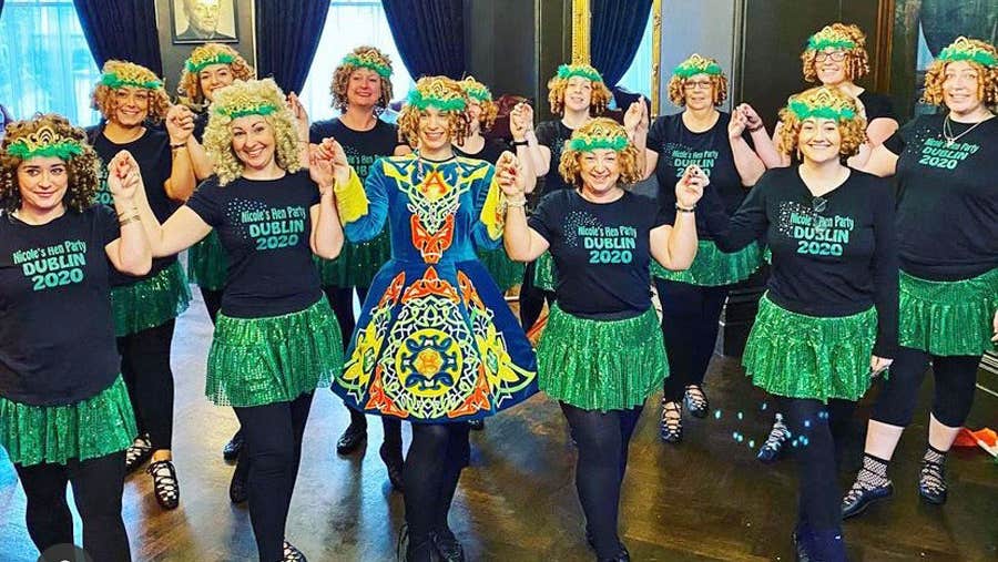 Group of girls dressed up in Irish dancing costumes and wigs