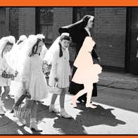Black and white photo of girls in short white communion dresses and veils holding small baskets, being led along a street by a young nun.