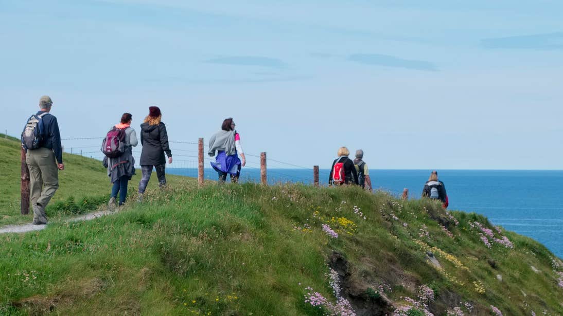 A group of people taking on Doolin Cliff Walk, Clare