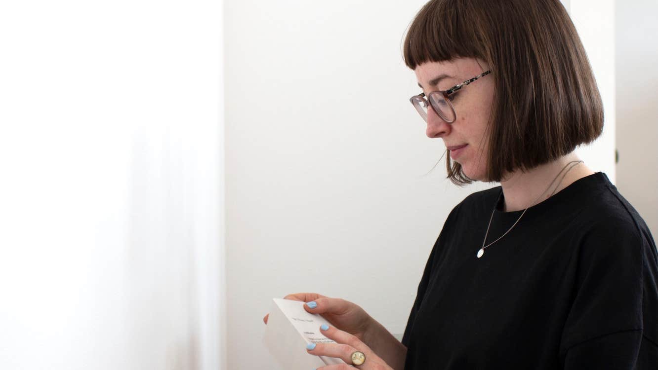 Kim Crowley looking at a book she's holding