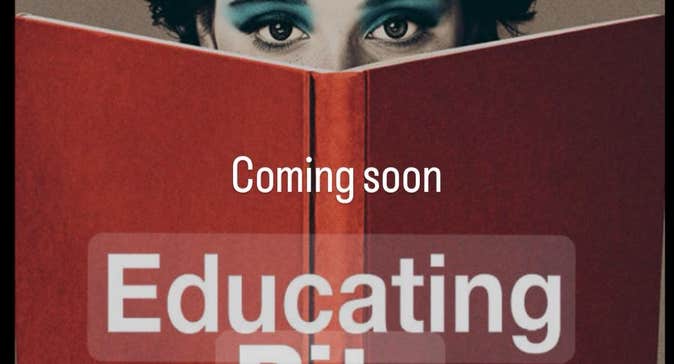 Image of large, open red covered book with woman's eyes appearing at the top