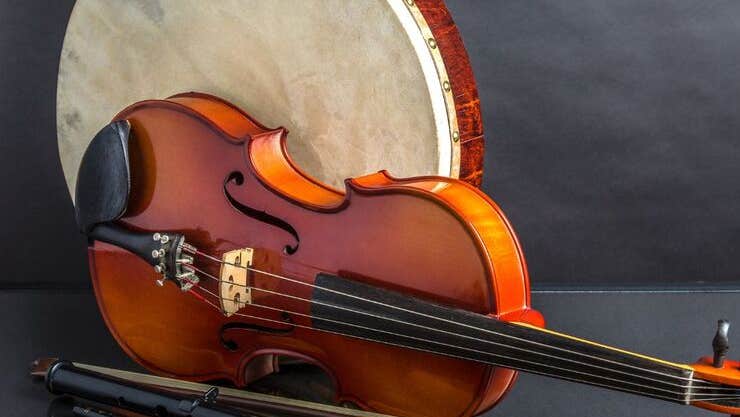 Traditional Irish Music Slow Session with Paudie O'Connor, image of a fiddle laid on its side with drum behind and bow