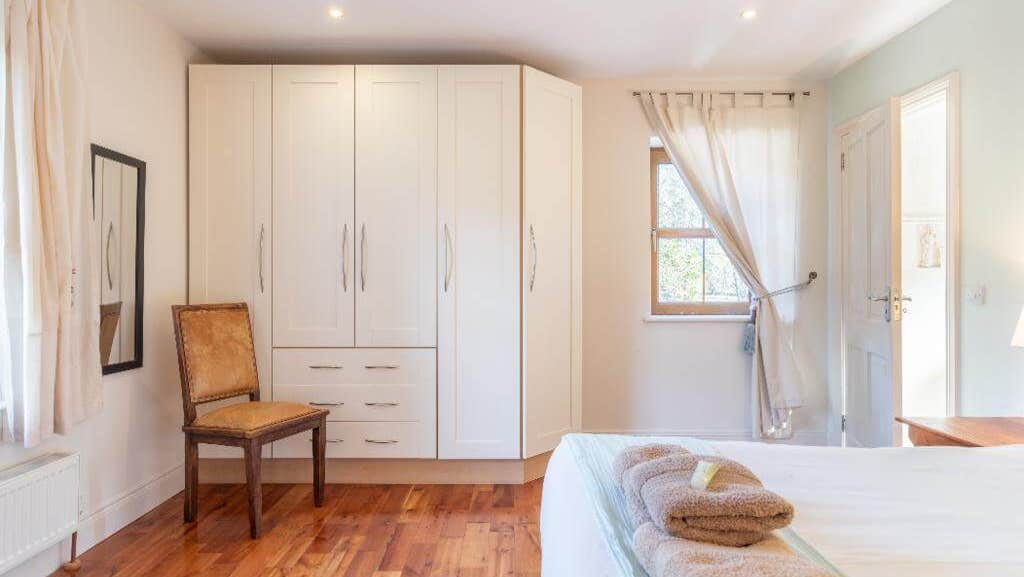 Large room with wooden floor and pastel tones