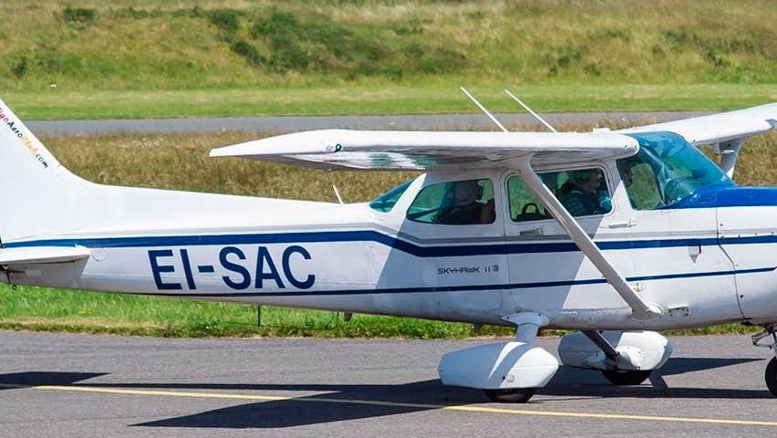 White Cessna airplane on tarmac