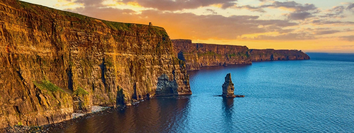 The Cliffs of Moher with an orange coloured sky above