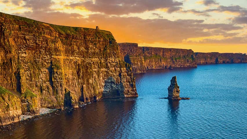 The Cliffs of Moher with an orange coloured sky above