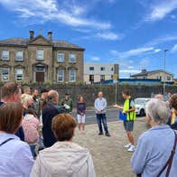 A group of people listening to their guide with Treaty Walking Tours