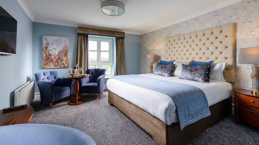 Deluxe king bedroom with high headboard