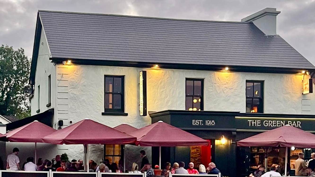 View of the outside of the The Green 1918 with outside dining tables