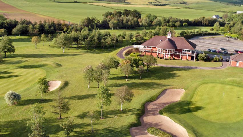 An aerial view of the golf course and club house of Kinsale Golf Club