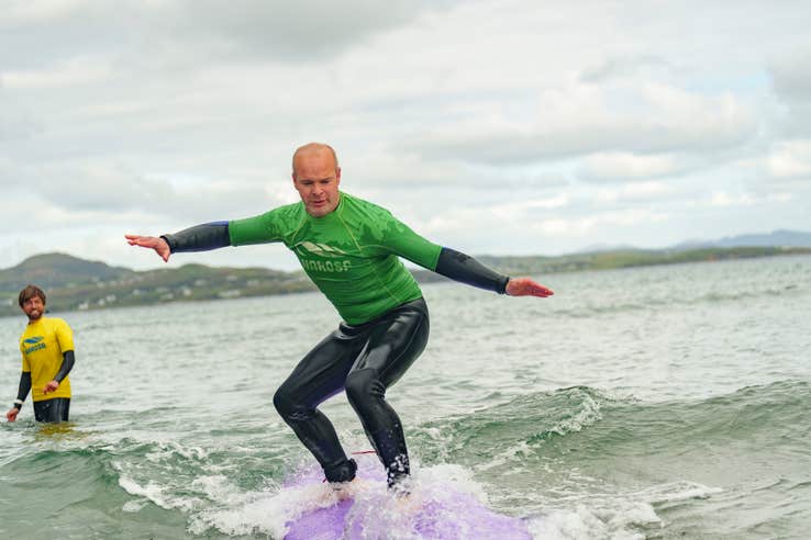Man surfing with Narosa Surf School on Marble Hill Beach in County Donegal