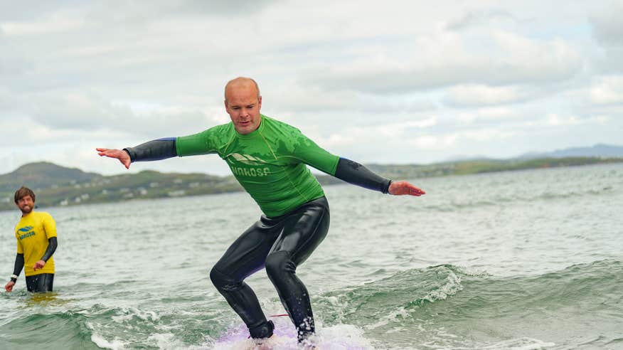 Man surfing with Narosa Surf School on Marble Hill Beach in County Donegal