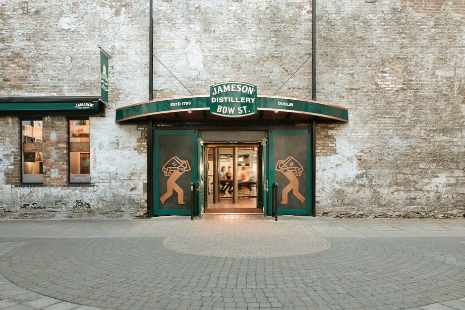 Entrance into Bow Street Jameson Distillery, featuring a green decorated entrance with the Jameson branding around.