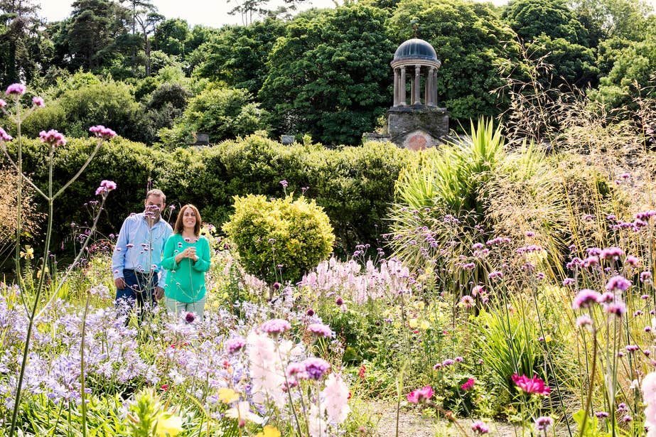 A couple walking through the gardens at Bantry House in West Cork