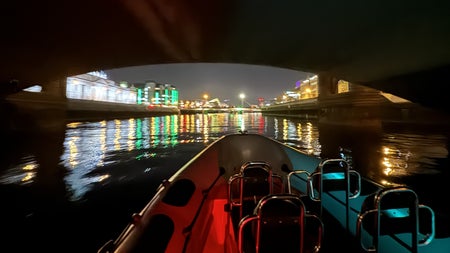 A view of the Customs house at night from a RIB under a bridge on the River Liffey