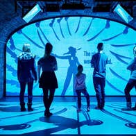 A group of people watching a visual display
