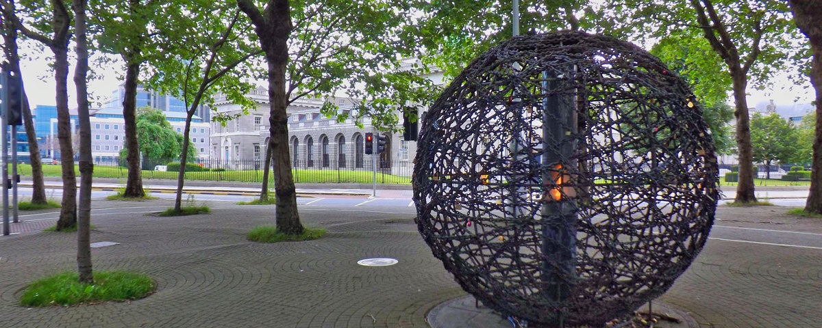 Spherical sculpture of intertwined links with an eternal flame representing universal human rights