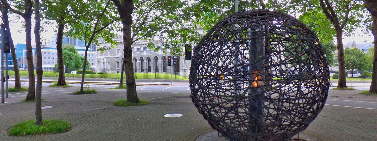 Spherical sculpture of intertwined links with an eternal flame representing universal human rights