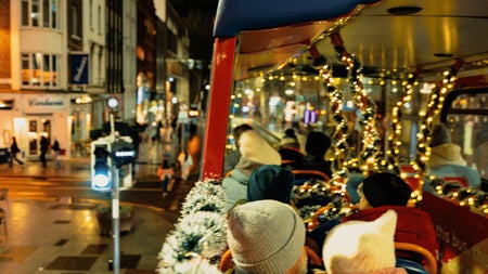 A photo from the top deck of the bus. Father and Daughter enjoying the views of the Christmas Lights Tour