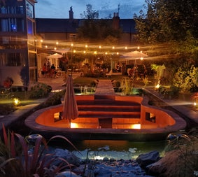 A view of the outdoor seating area and garden at La-La Café & Restaurant