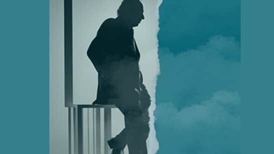 Side profile silhouette of man leaning on railings
