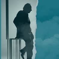 Side profile silhouette of man leaning on railings