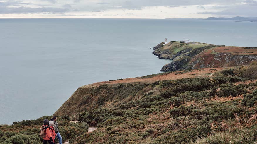 Aerial image of three people hiking along the Howth Cliff Walk in Howth, County Dublin