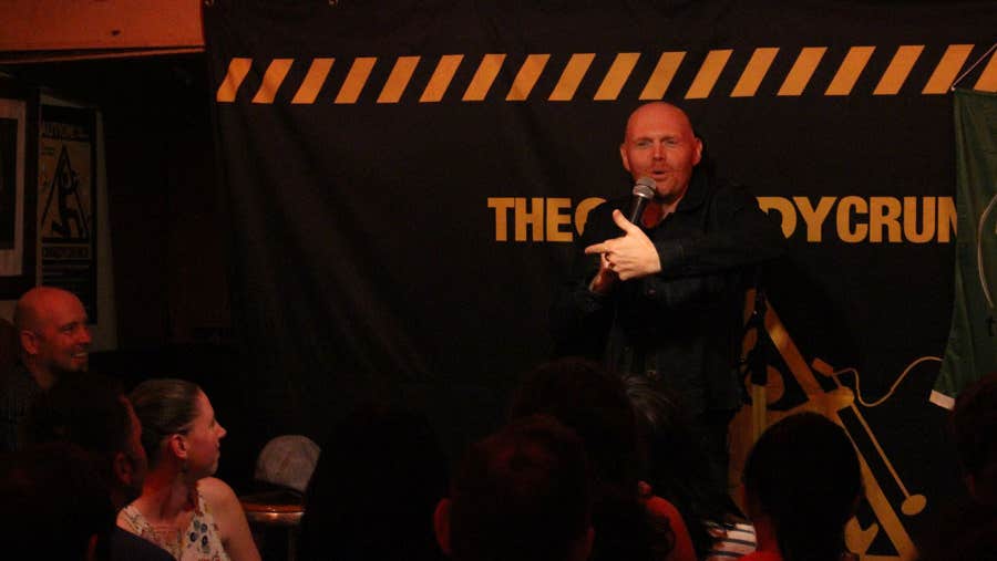 A comedian performing on stage at The Comedy Crunch