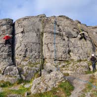 People abseiling down a rock face with the Irish Mountaineering Academy