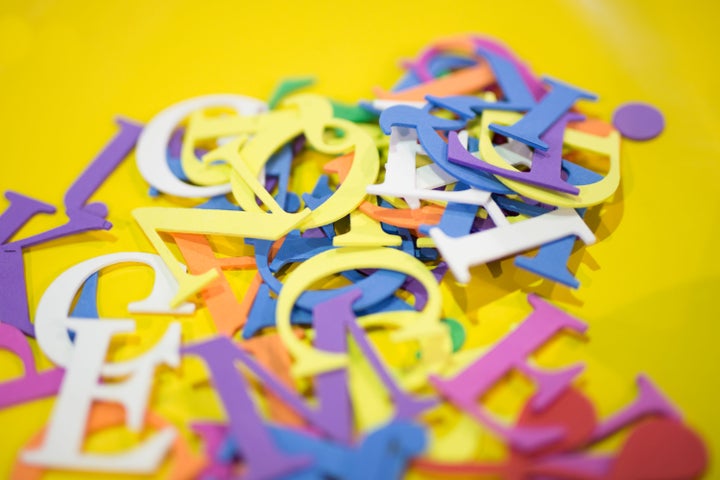 A pile of letters of different colours for use on a Sizzix die-cutting machine.