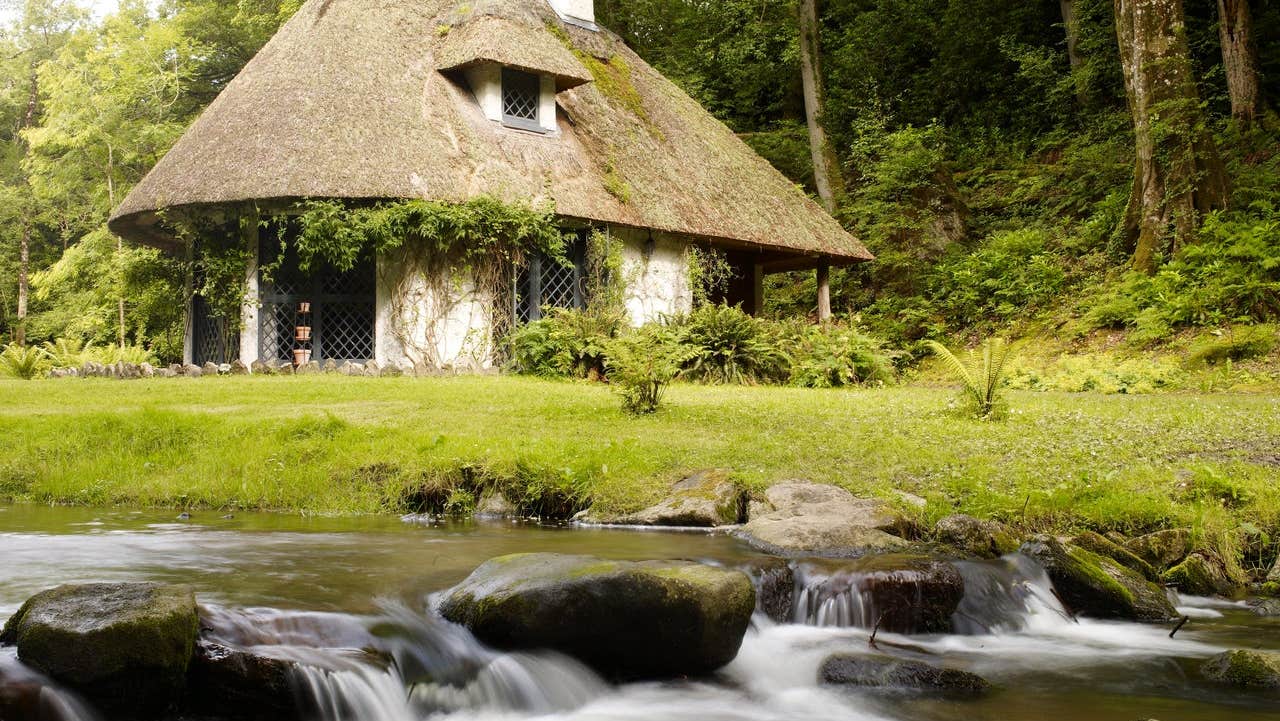 A thatched cottage beside a river