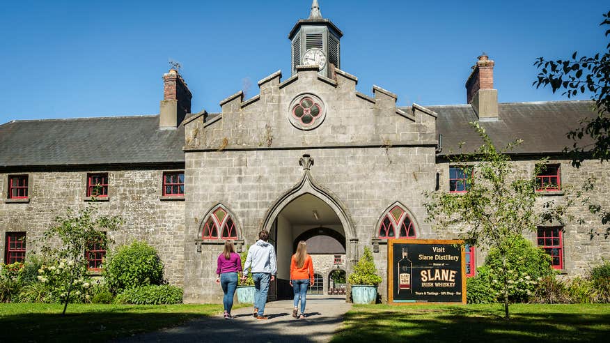 Three people walking into the Slane Distillery in County Meath