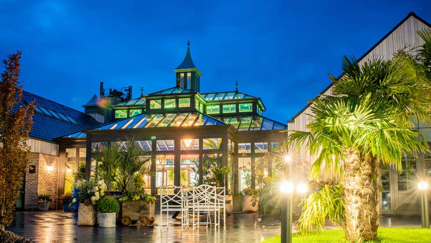 The exterior of The Shed Distillery lit up at night