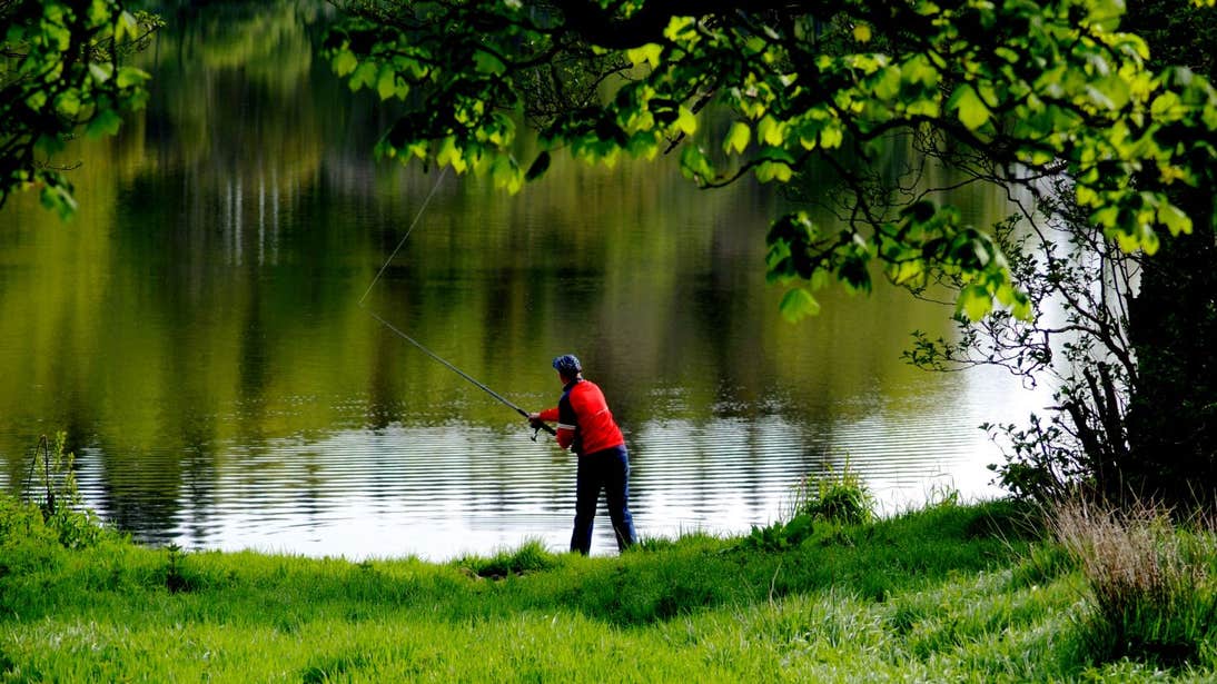 Person in a red t-shirt fishing at Lough Muckno, Monaghan