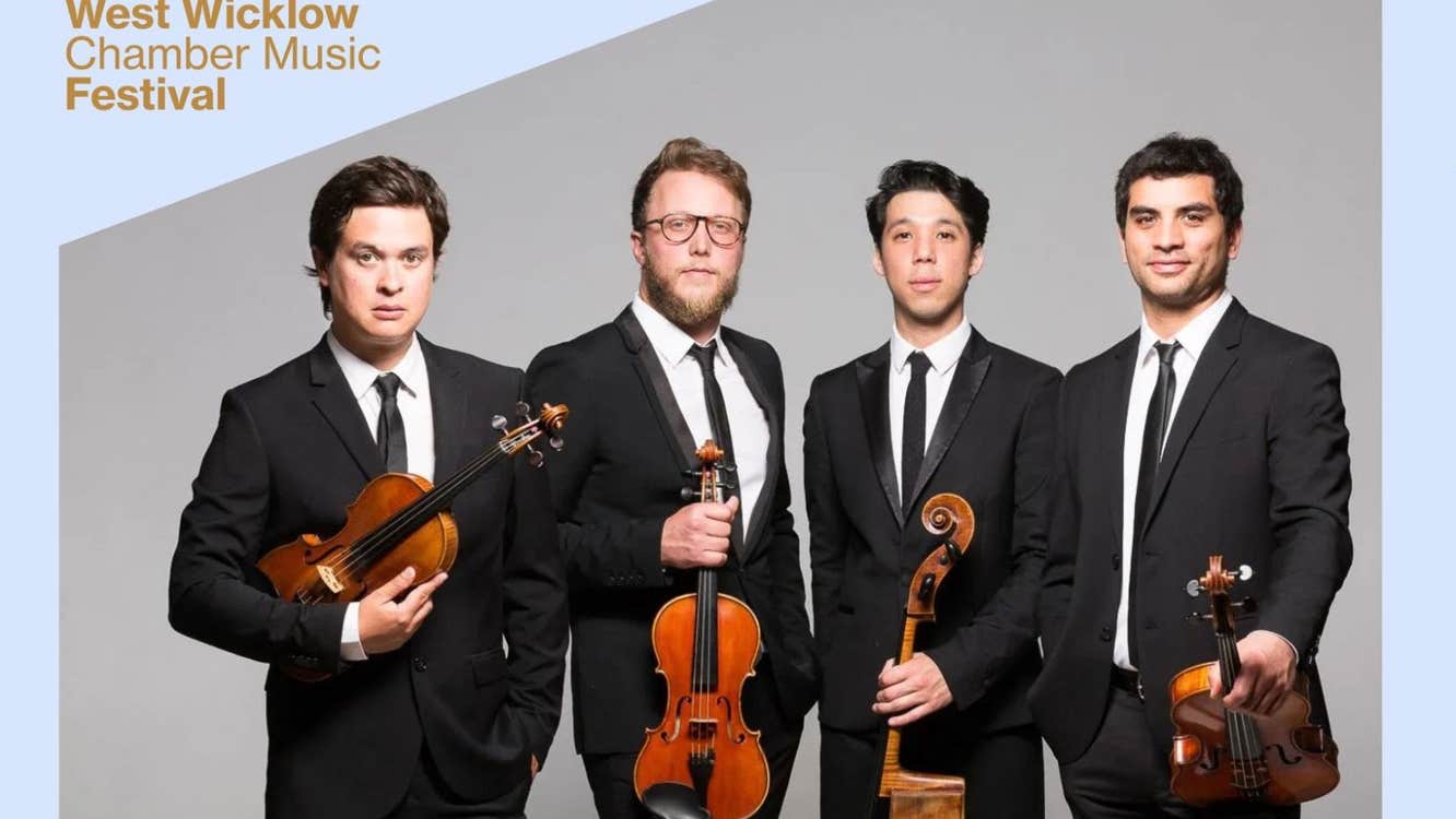 Quatuor Van Kuijk, a group of 4 men in black suits and ties, holding stringed instruments against plain grey background.