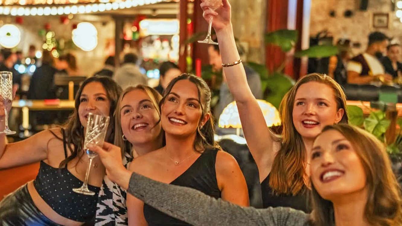 Flight Club Dublin group of women smiling and holding up cocktail glasses