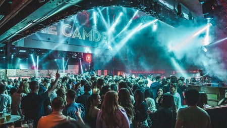 A crowd enjoying a disco with dramatic lighting