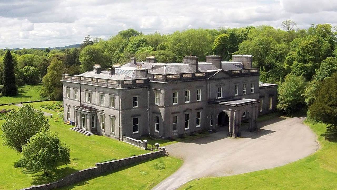 An aerial view of Temple House Estate sitting amid green grounds and trees