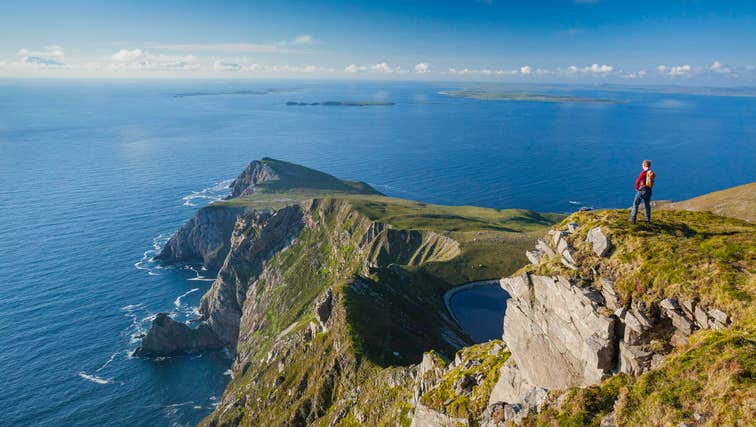 Man looking out to see from clifftop on Achill Island, Mayo