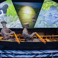 A model of curragh boat with three men rowing on display at the The Blasket Centre
