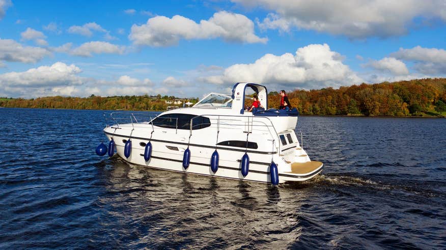 White boat with blue floats on the River Shannon
