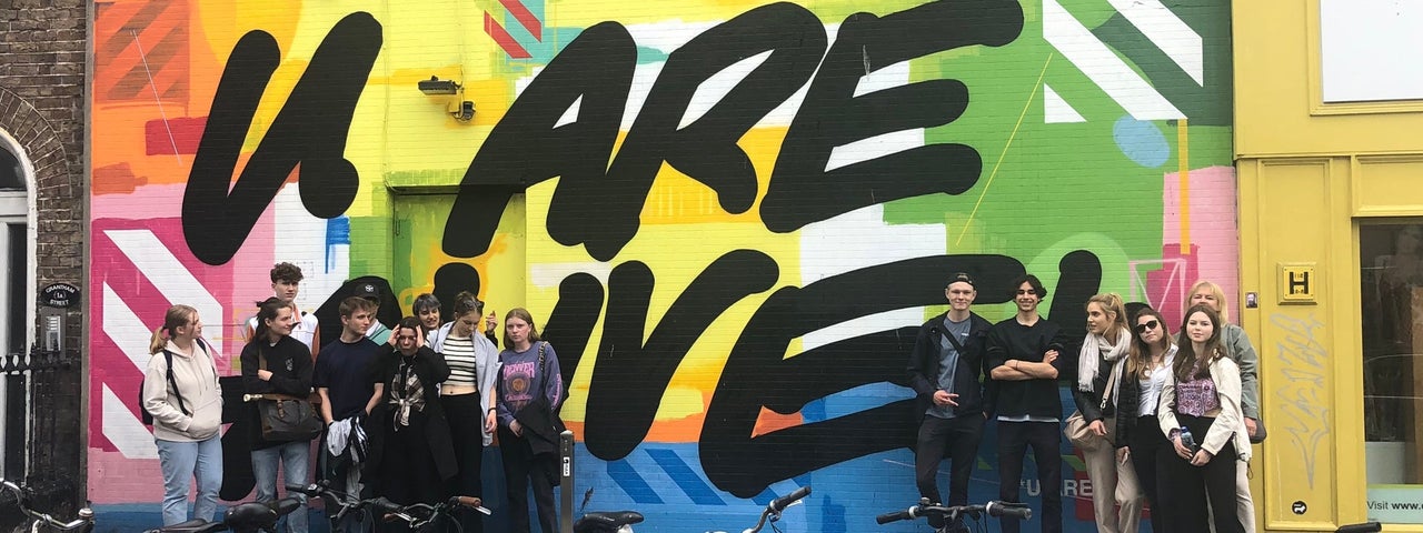 A tour group enjoying a street art tour of Dublin City with Artful Tours