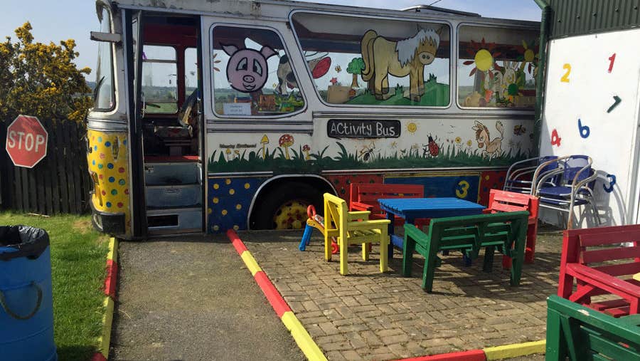 View of activity bus and patio area at Tick Tock Farm