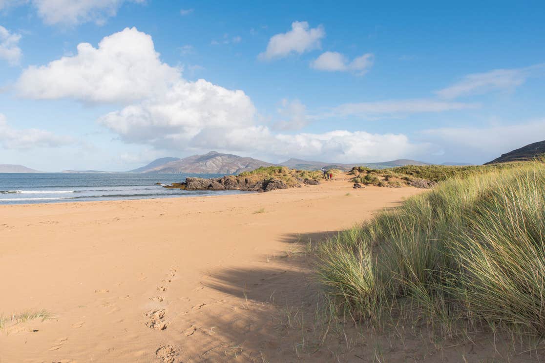 Footprints in the sand leading to the sea at Ballymastocker Beach, Donegal, Wild Atlantic Way.