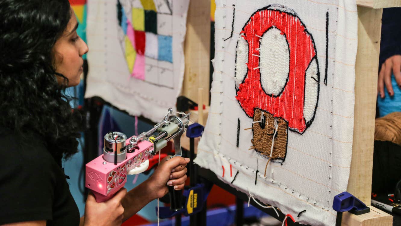 A guest enjoying herself tufting a Super Mario rug